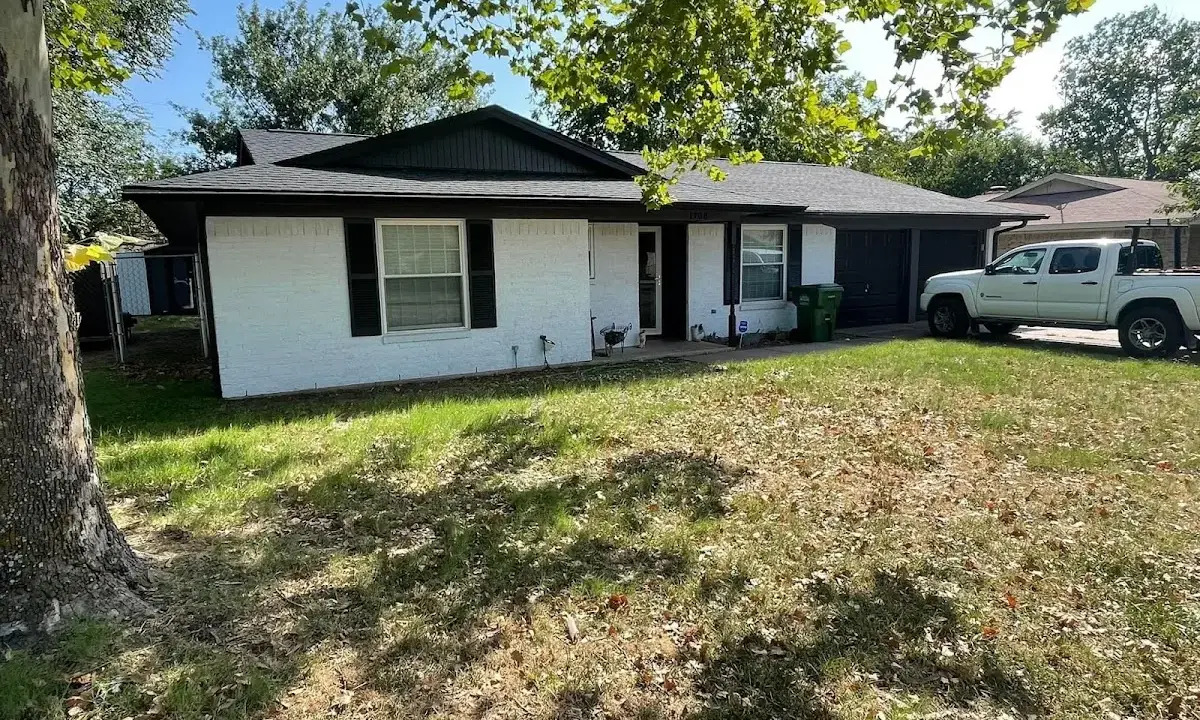 Professional roofing crew working on a residential roof in Airmont